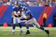 EAST RUTHERFORD, NJ - OCTOBER 21: Eli Manning #10 of the New York Giants hands off to Ahmad Bradshaw #44 during their game against the Washington Redskins at MetLife Stadium on October 21, 2012 in East Rutherford, New Jersey. (Photo by Al Bello/Getty Images)