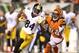 CINCINNATI, OH - OCTOBER 21: Antonio Brown #84 of the Pittsburgh Steelers runs with the ball while defended by Adam Jones #24 of the Cincinnati Bengals during the NFL game at Paul Brown Stadium on October 21, 2012 in Cincinnati, Ohio. (Photo by Andy Lyons/Getty Images)