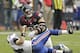HOUSTON, TX - NOVEMBER 04: Ryan Fitzpatrick #14 of the Buffalo Bills is knocked down by J.J. Watt #99 of the Houston Texans in the fourth quarter at Reliant Stadium on November 4, 2012 in Houston, Texas. Houston defeated Buffalo 21-9. (Photo by Bob Levey/Getty Images)