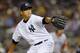 NEW YORK, NY - JULY 29: Hiroki Kuroda #18 the New York Yankees delivers a pitch against the Boston Red Sox in a MLB baseball game at Yankee Stadium on July 29, 2012 in the Bronx borough of New York City. (Photo by Rich Schultz/Getty Images)
