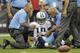 HOUSTON, TX - SEPTEMBER 30: Jake Locker #10 of the Tennessee Titans is helped up by Tennessee Titans medical staff after he took a hard hit from Glover Quin #29 of the Houston Texans at Reliant Arena at Reliant Park on September 30, 2012 in Houston, Texas. (Photo by Bob Levey/Getty Images)