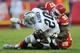 KANSAS CITY, MO - OCTOBER 28: Defensive linemen Allen Bailey #97 of the Kansas City Chiefs tackles running back Darren McFadden #20 of the Oakland Raiders for a loss during the fourth quarter on October 28, 2012 at Arrowhead Stadium in Kansas City, Missouri. Oakland defeated Kansas City 26-16. (Photo by Peter Aiken/Getty Images)