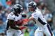 CHARLOTTE, NC - NOVEMBER 11: Peyton Manning #18 of the Denver Broncos hands the ball off to teammate Willis McGahee #23 during their game at Bank of America Stadium on November 11, 2012 in Charlotte, North Carolina. (Photo by Streeter Lecka/Getty Images)
