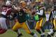 GREEN BAY, WI - NOVEMBER 04: Aaron Rodgers #12 of the Green Bay Packers looks to pass as Bryan Bulaga #75 blocks Darnell Dockett #90 of the Arizona Cardinals at Lambeau Field on November 4, 2012 in Green Bay, Wisconsin. The Packers defeated the Cardinals 31-17. (Photo by Jonathan Daniel/Getty Images)