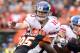 CINCINNATI, OH - NOVEMBER 11: Eli Manning #10 of the New York Giants is hit as he throws the ball by Wallace Gilberry #95 of the Cincinnati Bengals at Paul Brown Stadium on November 11, 2012 in Cincinnati, Ohio. (Photo by Andy Lyons/Getty Images)