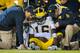 LINCOLN, NE - OCTOBER 27: Quarterback Denard Robinson #16 of the Michigan Wolverines is attended to by trainers after being injured during their game against the Nebraska Cornhuskers at Memorial Stadium on October 27, 2012 in Lincoln, Nebraska. (Photo by Eric Francis/Getty Images)