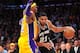 November 13, 2012; Los Angeles, CA, USA; San Antonio Spurs power forward Tim Duncan (21) moves the ball against the defense of Los Angeles Lakers center Dwight Howard (12) during the second half at Staples Center. Mandatory Credit: Gary A. Vasquez-US PRESSWIRE