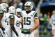 Tim Tebow (15) stands amongst his offensive line.