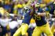 ANN ARBOR, MI - NOVEMBER 26: Courtney Avery #5 of the Michigan Wolverines celebrates a late fourth quarter interception to beat the Ohio State Buckeyes 40-34 Will Heininger #39 at Michigan Stadium on November 26, 2011 in Ann Arbor, Michigan. (Photo by Gregory Shamus/Getty Images)