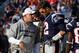 Nov 11, 2012; Foxborough, MA, USA; New England Patriots quarterback Tom Brady (12) talks with offensive coordinator Josh McDaniels on the sideline during the second quarter against the Buffalo Bills at Gillette Stadium. The Patriots defeated the Bills 37-31. Mandatory Credit: David Butler II-US PRESSWIRE