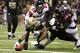 NEW ORLEANS, LA - NOVEMBER 11: Marques Colston #12 of the New Orleans Saints stretches for yardage while being held by Thomas DeCoud #28 and Dunta Robinson #23 of the Atlanta Falcons at Mercedes-Benz Superdome on November 11, 2012 in New Orleans, Louisiana. The Saints defeated the Falcons 31-27. (Photo by Wesley Hitt/Getty Images)