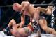 Nov 17, 2012; Montreal, QC, Canada; Georges St-Pierre (black) throws punches on Carlos Condit (white) during first round action of their Welterweight Championship bout at UFC 154 at the Bell Centre. Mandatory Credit: Eric Bolte-US PRESSWIRE