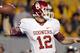 MORGANTOWN, WV - NOVEMBER 17: Landry Jones #12 of the Oklahoma Sooners drops back to pass against the West Virginia Mountaineers during the game on November 17, 2012 at Mountaineer Field in Morgantown, West Virginia. (Photo by Justin K. Aller/Getty Images)