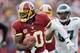 WASHINGTON, DC - NOVEMBER 18: Quarterback Robert Griffin III #10 of the Washington Redskins rushes the ball in front of defensive tackle Cullen Jenkins #97 of the Philadelphia Eagles during the first half at FedEx Field on November 18, 2012 in Washington, DC. (Photo by Rob Carr/Getty Images)