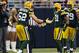 Clay Matthews (52) and Charles Woodson (21) didn't play Sunday, but the Packers found a way to get it done on defense.