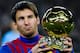 BARCELONA, SPAIN - JANUARY 15: Lionel Messi of FC Barcelona holds the Ballon d'Or trophy prior to the La Liga match between FC Barcelona and Real Betis Balompie at Camp Nou on January 15, 2012 in Barcelona, Spain. (Photo by David Ramos/Getty Images)