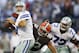 ARLINGTON, TX - NOVEMBER 18: Tony Romo #9 of the Dallas Cowboys looks downfield for a receiver under pressure from John Hughes #93 of the Cleveland Browns at Cowboys Stadium on November 18, 2012 in Arlington, Texas. The Cowboys defeated the Browns 23-20. (Photo by Wesley Hitt/Getty Images)