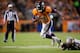 DENVER, CO - OCTOBER 28: Running back Ronnie Hillman #21 of the Denver Broncos is tripped up[ by Cornerback Jabari Greer #33 of the New Orleans Saints at Sports Authority Field Field at Mile High on October 28, 2012 in Denver, Colorado. The Broncos defeated the Saints 34-14. (Photo by Justin Edmonds/Getty Images)