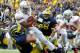 ANN ARBOR, MI - NOVEMBER 26: Braxton Miller #5 of the Ohio State Buckeyes is sacked by Ryan Van Bergen #53 of the Michigan Wolverines at Michigan Stadium on November 26, 2011 in Ann Arbor, Michigan. (Photo by Gregory Shamus/Getty Images)