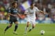 MADRID, SPAIN - SEPTEMBER 18: Angel di Maria of Real Madrid beats David Silva of Manchester City FC during the UEFA Champions League Group D match between Real Madrid and Manchester City FC at Estadio Santiago Bernabeu on September 18, 2012 in Madrid, Spain. (Photo by Alex Livesey/Getty Images)
