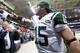 ST. LOUIS, MO - NOVEMBER 18: quarterback Tim Tebow #15 of the New York Jets tosses a towel to a fan after the game against the St. Louis Rams at the Edward Jones Dome on November 18, 2012 in St. Louis, Missouri. (Photo by David Welker/Getty Images)