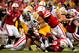 LINCOLN, NE - NOVEMBER 25: Running back Marcus Coker #34 of the Iowa Hawkeyes is surrounded by the Nebraska Cornhusker defense during their game at Memorial Stadium November 25, 2011 in Lincoln, Nebraska. Nebraska defeated Iowa 20-7. (Photo by Eric Francis/Getty Images)
