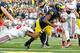 ANN ARBOR, MI - NOVEMBER 26: Denard Robinson #16 of the Michigan Wolverines gets in for a second quarter touchdown past the tackle of Etienne Sabino #6 of the Ohio State Buckeyes at Michigan Stadium on November 26, 2011 in Ann Arbor, Michigan. (Photo by Gregory Shamus/Getty Images)