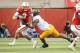 LINCOLN, NE - NOVEMBER 17: Quarterback Taylor Martinez #3 of the Nebraska Cornhuskers tries to slip past linebacker Aaron Hill #57 of the Minnesota Golden Gophers during their game at Memorial Stadium on November 17, 2012 in Lincoln, Nebraska. Nebraska won 38-14. (Photo by Eric Francis/Getty Images)