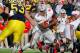 ANN ARBOR, MI - NOVEMBER 26: Braxton Miller #5 of the Ohio State Buckeyes looks for running room next to Ryan Van Bergen #53 of the Michigan Wolverines at Michigan Stadium on November 26, 2011 in Ann Arbor, Michigan. Michigan won the game 40-34. (Photo by Gregory Shamus/Getty Images)