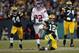 GREEN BAY, WI - JANUARY 15: Aaron Rodgers #12 of the Green Bay Packers slides with the ball after a run against the New York Giants during their NFC Divisional playoff game at Lambeau Field on January 15, 2012 in Green Bay, Wisconsin. (Photo by Jamie Squire/Getty Images)