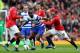 MANCHESTER, ENGLAND - APRIL 08: Samba Diakite of Queens Park Rangers holds off Wayne Rooney of Manchester United during the Barclays Premier League match between Manchester United and Queens Park Rangers at Old Trafford on April 8, 2012 in Manchester, England. (Photo by Alex Livesey/Getty Images)