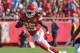 KANSAS CITY, MO - NOVEMBER 18: Running back Jamaal Charles #25 of the Kansas City Chiefs rushes past defensive back Adam Jones #24 of the Cincinnati Bengals during the first half on November 18, 2012 at Arrowhead Stadium in Kansas City, Missouri. Cincinnati defeated Kansas City 28-6. (Photo by Peter Aiken/Getty Images)