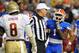 GAINESVILLE, FL - NOVEMBER 26: NCAA referee Matt Moore separates running back Chris Rainey #1 of the Florida Gators and defensive tackle Timmy Jerrigan #8 of the Florida State Seminoles November 26, 2011 at Ben Hill Griffin Stadium in Gainesville, Florida. (Photo by Al Messerschmidt/Getty Images)