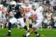 Oct 27, 2012; University Park, PA, USA; Ohio State Buckeyes quarterback Braxton Miller (5) runs with the ball past Penn State Nittany Lions linebacker Gerald Hodges (6) during the first quarter at Beaver Stadium. Mandatory Credit: Rich Barnes-US PRESSWIRE