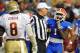 GAINESVILLE, FL - NOVEMBER 26: NCAA referee Matt Moore separates running back Chris Rainey #1 of the Florida Gators and defensive tackle Timmy Jerrigan #8 of the Florida State Seminoles November 26, 2011 at Ben Hill Griffin Stadium in Gainesville, Florida. (Photo by Al Messerschmidt/Getty Images)