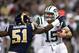 ST. LOUIS, MO - NOVEMBER 18: Quarterback Tim Tebow #15 of the New York Jets stiff arms linebacker Mario Haggan #51 of the St. Louis Rams during the game at the Edward Jones Dome on November 18, 2012 in St. Louis, Missouri. (Photo by David Welker/Getty Images)