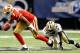 NEW ORLEANS, LA - AUGUST 12: Colin Kaepernick # 7 of the San Francisco 49ers slips the tackle of Leigh Torrence # 24 New Orleans Saints during a preseason game at Louisiana Superdome on August 12, 2011 in New Orleans, Louisiana. (Photo by Sean Gardner/Getty Images)