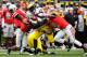 COLUMBUS, OH - NOVEMBER 24: Denard Robinson #16 of the Michigan Wolverines breaks through the tackle attempts by Travis Howard #7 of the Ohio State Buckeyes and Christian Bryant #2 of the Ohio State Buckeyes in the first half on his way to a 67-yard touchdown run at Ohio Stadium on November 24, 2012 in Columbus, Ohio. (Photo by Jamie Sabau/Getty Images)