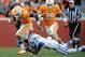 Nov 24, 2012; Knoxville, TN, USA; Tennessee Volunteers running back Marlin Lane (15) runs the ball while Kentucky Wildcats cornerback Martavius Neloms (1) attempts to tackle him at Neyland Stadium. Tennessee won by a score of 37 to 17. Mandatory Credit: Randy Sartin-US PRESSWIRE