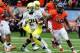 CORVALLIS, OR - NOVEMBER 24: Running back Kenjon Barner #24 of the Oregon Ducks runs past linebacker D.J. Alexander #4 and linebacker Michael Doctor #40 of the Oregon State Beavers in the first quarter of the game on November 24, 2012 at Reser Stadium in Corvallis, Oregon. The Ducks won the game 48-24. (Photo by Steve Dykes/Getty Images)