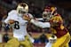 LOS ANGELES, CA - NOVEMBER 24: Theo Riddick #6 of the Notre Dame Fighting Irish gives Jawanza Starling #29 of the USC Trojans a stiff arm as he carries the ball during a 22-13 Notre Dame win at Los Angeles Memorial Coliseum on November 24, 2012 in Los Angeles, California. (Photo by Harry How/Getty Images)