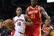 Feb 28, 2012; Houston, TX, USA; Toronto Raptors shooting guard DeMar DeRozan (10) drives against Houston Rockets center Samuel Dalembert (21) during the first quarter at the Toyota Center. Mandatory Credit: Thomas Campbell-US Presswire