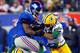 EAST RUTHERFORD, NJ - NOVEMBER 25: Running back Andre Brown #35 of the New York Giants hurts his leg while getting tackled by free safety M.D. Jennings #43 and cornerback Tramon Williams #38 of the Green Bay Packers in the fourth quarterat MetLife Stadium on November 25, 2012 in East Rutherford, New Jersey. (Photo by Rich Schultz/Getty Images)