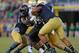 SOUTH BEND, IN - NOVEMBER 17: Deandre Martin #21 of the Wake Forest Demon Deacons is tackled by members of the Notre Dame Fighting Irish defense incluiding Stephon Tuitt #7 (R) at Notre Dame Stadium on November 17, 2012 in South Bend, Indiana. Notre Dame defeated Wake Forest 38-0. (Photo by Jonathan Daniel/Getty Images)