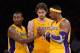 LOS ANGELES, CA - NOVEMBER 16: Metta World Peace #15 and Pau Gasol #16 of the Los Angeles Lakers help Dwight Howard #12 with his contact lens during the basketball game against Phoenix Suns at Staples Center on November 16, 2012 in Los Angeles, California. NOTE TO USER: User expressly acknowledges and agrees that, by downloading and or using this photograph, User is consenting to the terms and conditions of the Getty Images License Agreement. (Photo by Kevork Djansezian/Getty Images)