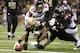 NEW ORLEANS, LA - NOVEMBER 11: Marques Colston #12 of the New Orleans Saints stretches for yardage while being held by Thomas DeCoud #28 and Dunta Robinson #23 of the Atlanta Falcons at Mercedes-Benz Superdome on November 11, 2012 in New Orleans, Louisiana. The Saints defeated the Falcons 31-27. (Photo by Wesley Hitt/Getty Images)