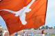 PASADENA, CA - SEPTEMBER 17: A cheerleader waves the Texas Longhorns flag after a score against the UCLA Bruins at Rose Bowl on September 17, 2011 in Pasadena, California. (Photo by Harry How/Getty Images)