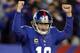 Nov 25, 2012; East Rutherford, NJ, USA; New York Giants quarterback Eli Manning (10) reacts after throwing a touchdown pass to wide receiver Victor Cruz (not pictured) against the Green Bay Packers during the game at Metlife Stadium. Mandatory Credit: Andrew Mills/THE STAR-LEDGER via US PRESSWIRE