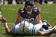 CHICAGO, IL - SEPTEMBER 09: Shea McClellin #99 of the Chicago Bears looks down at Andrew Luck #12 of the Indianapolis Colts after a hit during their 2012 NFL season opener at Soldier Field on September 9, 2012 in Chicago, Illinois. The Bears defeated the Colts 41-21. (Photo by Jonathan Daniel/Getty Images)