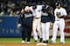 NEW YORK, NY - OCTOBER 13: Derek Jeter #2 of the New York Yankees is carried off of the field by trainer Steve Donohue (L) and manager Joe Girardi after Jeter injured his leg in the top of the 12th inning against the Detroit Tigers during Game One of the American League Championship Series at Yankee Stadium on October 13, 2012 in the Bronx borough of New York City, New York. (Photo by Al Bello/Getty Images)